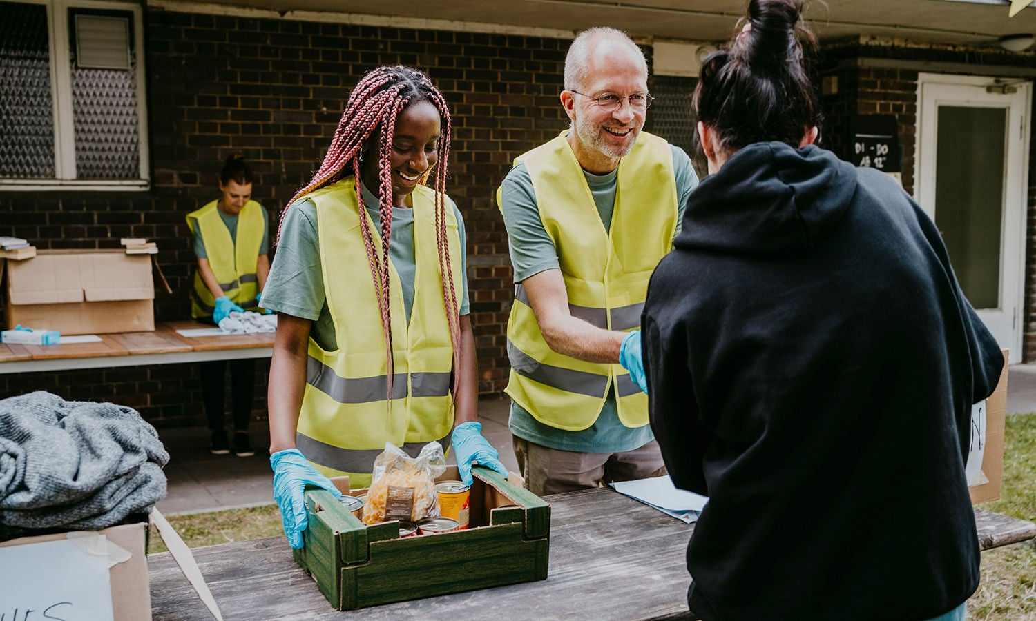 A group of volunteers standing around a table